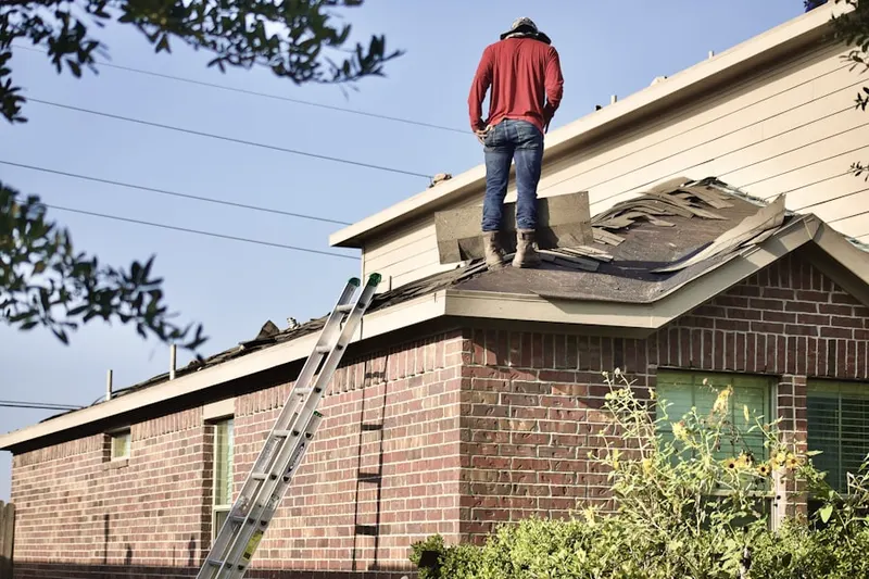 Professional roofer working on a residential roof in East Rockaway